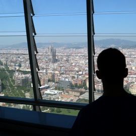 Un visitant contempla les vistes de la ciutat (Sagrada Família i avinguda Diagonal a l'esquerra), des del mirador de la torre Glòries.