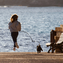 Imagen recurso de una niña paseando a su perro en la localidad mallorquina de Andratx. - EFE