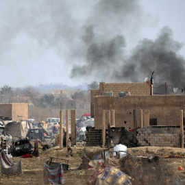 Los miembros del Estado Islámico caminan en el último barrio asediado de la aldea de Baghouz, provincia de Deir Al Zor, Siria. REUTERS / Rodi Said