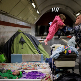 18/03/2022 Alexander Ivoshenko coge en brazos a su hija Kira, mientras su esposa sujeta a su hijo en la estación de metro donde se refugian de los ataques rusos en Kiev, Ucrania