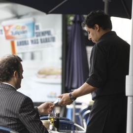 Un camarero atiende a un cliente en una terraza en el centro de Madrid. E.P.