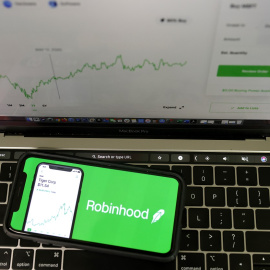 The Robinhood logo is displayed on an iPhone.