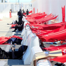 Diversos inmigrantes que permanecen en el puerto de Algeciras desde hace varios, esperan junto a las zonas que ellos mismos han construído para protegerse del sol. Salvamento Marítimo ha rescatado este domingo a 123 inmigrantes de doce pate