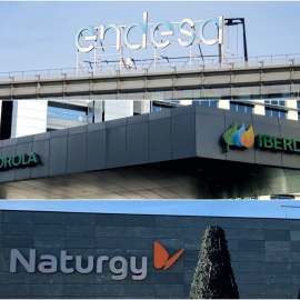 Los logos de las tres principales compañías eléctricas (Endesa, Iberdrola y Naturgy), en sus sedes en Madrid. E.P.