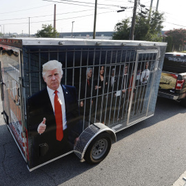 Un seguidor del expresidente estadounidense Donald Trump con un remolque que muestra imágenes de líderes demócratas en una celda, a las puertas de la cárcel del condado de Fulton, en Atlanta, Georgia, este 24 de agosto de 2023.