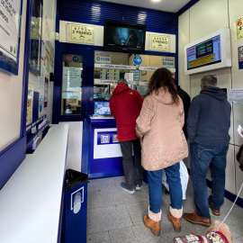 Varias personas compran décimos de Lotería de Navidad en una Administración del centro de Madrid. E.P./Eduardo Parra