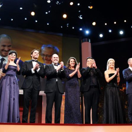 El director de la Berlinale, Dieter Kosslick (d), y la presentadora Anke Engelke (i) aplauden junto a los miembros del jurado, desde la izquierda, Audrey Tautou, Daniel Bruehl, Matthew Weiner, Claudia Llosa, Bong Joon-ho, Martha de Laurenti