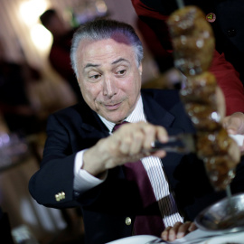 El presidente de Brasil Michel Temer comiendo carne con importantes empresarios