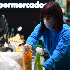 Una mujer durante su jornada laboral como trabajadora esencial en un supermercado de Madrid el 17 de marzo de 2020. GABRIEL BOUYS / AFP