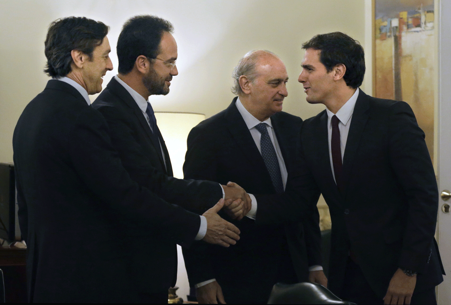 El líder de Ciudadanos saluda a Rafael Hernando y Antonio Hernando en presencia del ministro del Interior, Jorge Fernández Díaz, durante la reunión del pacto contra el terrorismo yihadista. EFE